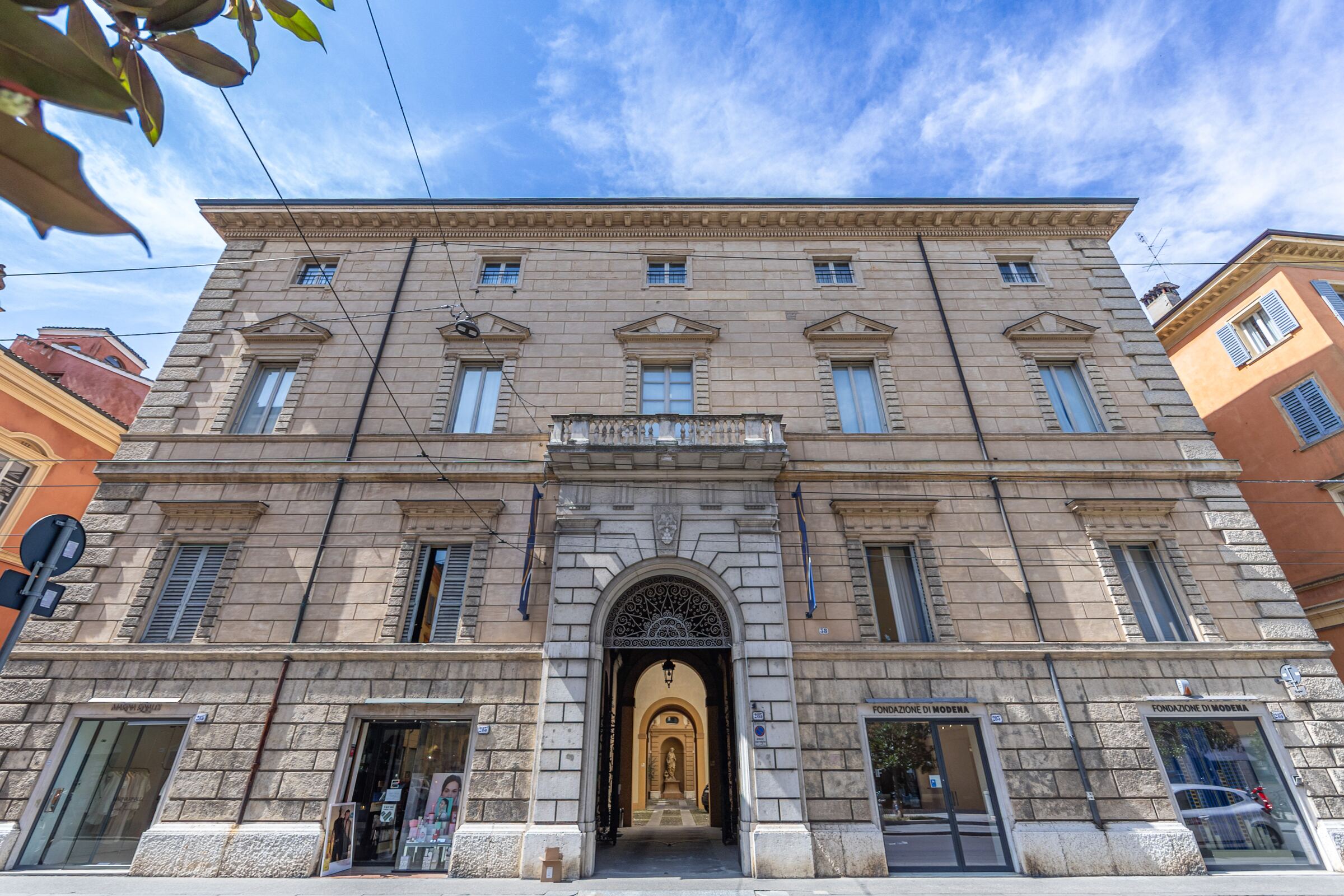 La facciata neoclassica di Palazzo Montecuccoli, con il portone d'ingresso sulla Via Emilia
